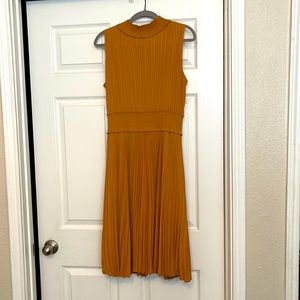 Mustard/gold colored pleated dress Nice material wrinkle resistant! NWOT